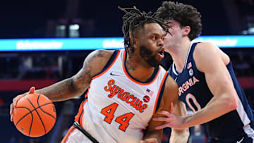 Syracuse Orange center Eddie Lampkin Jr. (44) drives against Virginia Cavaliers forward Blake Buchanan (0) during the first half at the JMA Wireless Dome.