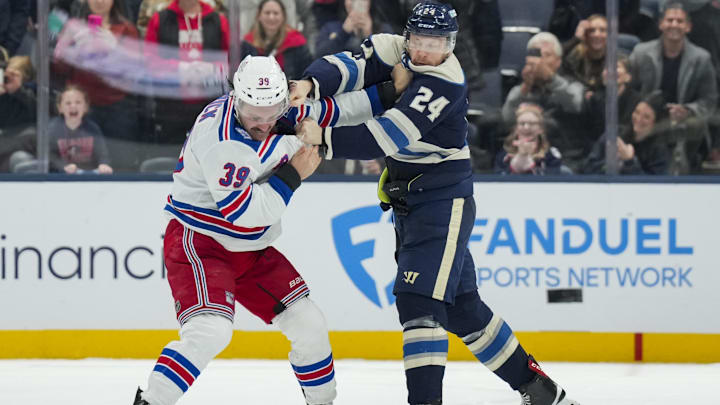 Nov 15, 2025; Columbus, Ohio, USA;  New York Rangers center Sam Carrick (39) fights Columbus Blue Jackets right wing Mathieu Olivier (24) in the second period at Nationwide Arena. Mandatory Credit: Aaron Doster-Imagn Images