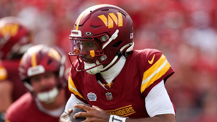 Sep 8, 2024; Tampa, Florida, USA; Washington Commanders quarterback Jayden Daniels (5) drops back to pass against the Tampa Bay Buccaneers in the first quarter at Raymond James Stadium. Mandatory Credit: Nathan Ray Seebeck-Imagn Images