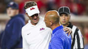 Mississippi Rebels head coach Lane Kiffin observes pregame warmups against the Florida Gators