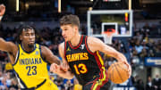 Apr 14, 2024; Indianapolis, Indiana, USA; Atlanta Hawks guard Bogdan Bogdanovic (13) dribbles the ball while  Indiana Pacers forward Aaron Nesmith (23) defends in the second half at Gainbridge Fieldhouse. Mandatory Credit: Trevor Ruszkowski-USA TODAY Sports