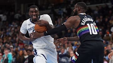 Nov 24, 2025; Memphis, Tennessee, USA; Memphis Grizzlies forward Vince Williams Jr. (5) drives to the basket as Denver Nuggets guard Tim Hardaway Jr. (10) defends during the third quarter at FedExForum. Mandatory Credit: Petre Thomas-Imagn Images