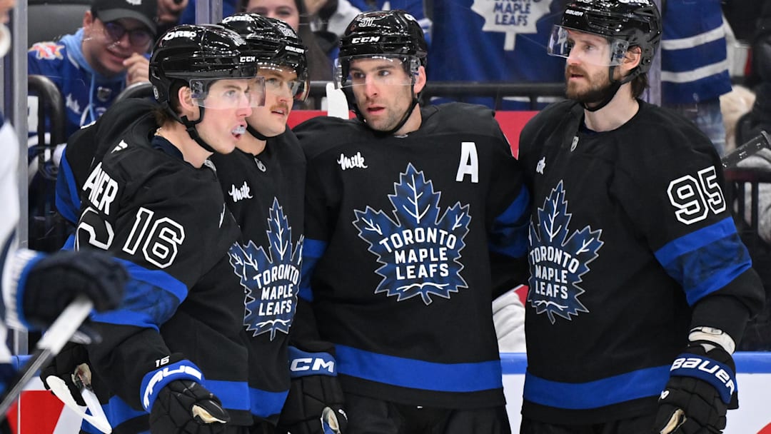 Dec 23, 2024; Toronto, Ontario, CAN;  Toronto Maple Leafs forward John Tavares (91) celebrates with forwards Mitch Marner (16) and William Nylander (88) and defenseman Oliver Ekman-Larsson (95) after scoring a goal against the Winnipeg Jets in the third period at Scotiabank Arena. Mandatory Credit: Dan Hamilton-Imagn Images