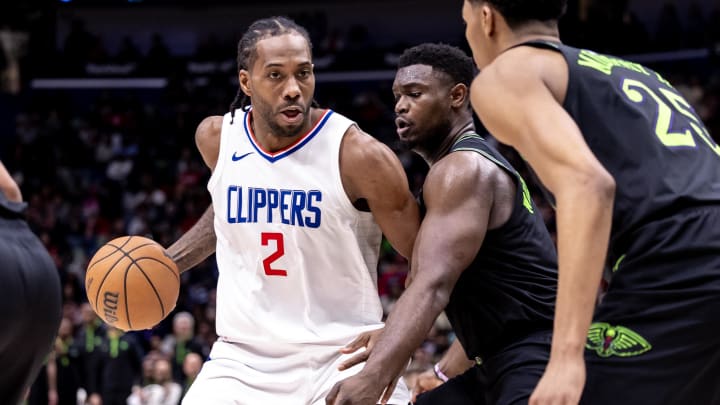 Mar 15, 2024; New Orleans, Louisiana, USA;  LA Clippers forward Kawhi Leonard (2) dribbles against New Orleans Pelicans forward Zion Williamson (1) and guard Trey Murphy III (25) during the second half at Smoothie King Center. 