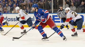 May 24, 2024; New York, New York, USA; New York Rangers defenseman Jacob Trouba (8) plays the puck against Florida Panthers center Carter Verhaeghe (23) during the first period in game two of the Eastern Conference Final of the 2024 Stanley Cup Playoffs at Madison Square Garden. Mandatory Credit: Vincent Carchietta-USA TODAY Sports