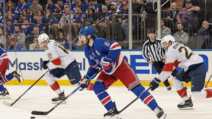 May 24, 2024; New York, New York, USA; New York Rangers defenseman Jacob Trouba (8) plays the puck against Florida Panthers center Carter Verhaeghe (23) during the first period in game two of the Eastern Conference Final of the 2024 Stanley Cup Playoffs at Madison Square Garden. Mandatory Credit: Vincent Carchietta-USA TODAY Sports