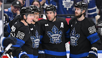 Dec 23, 2024; Toronto, Ontario, CAN;  Toronto Maple Leafs forward John Tavares (91) celebrates with forwards Mitch Marner (16) and William Nylander (88) and defenseman Oliver Ekman-Larsson (95) after scoring a goal against the Winnipeg Jets in the third period at Scotiabank Arena. Mandatory Credit: Dan Hamilton-Imagn Images