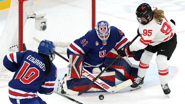 Feb 19, 2026; Milan, Italy; Daryl Watts of Canada in action with Aerin Frankel and Laila Edwards of United States  in the women's ice hockey gold medal game during the Milano Cortina 2026 Olympic Winter Games at Milano Santagiulia Ice Hockey Arena. Mandatory Credit: Mike Segar/Reuters via Imagn Images