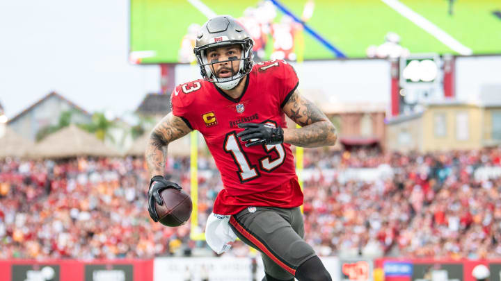 Dec 24, 2023; Tampa, Florida, USA;Tampa Bay Buccaneers wide receiver Mike Evans (13) catches the touchdown against the Jacksonville Jaguars in the second quarter  at Raymond James Stadium. Mandatory Credit: Jeremy Reper-USA TODAY Sports