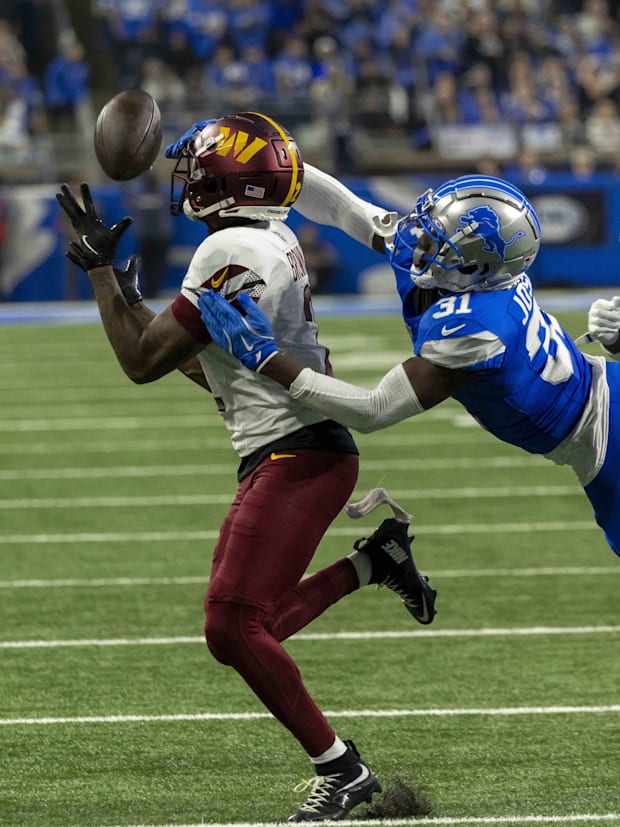Washington Commanders wide receiver Dyami Brown (2) receives a pass defended by Detroit Lions safety Kerby Joseph.