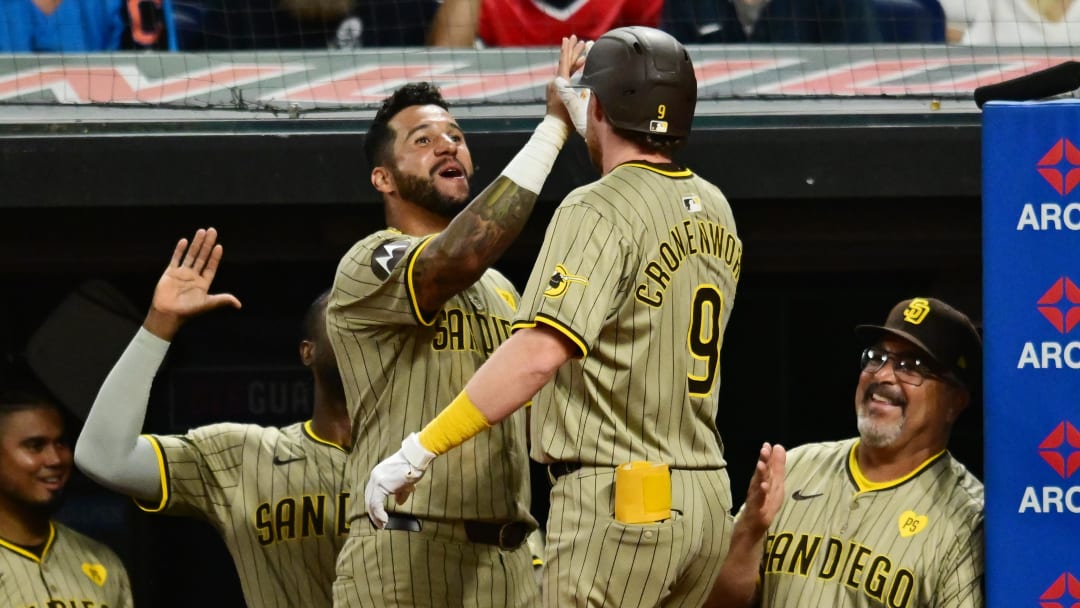 Jul 20, 2024; Cleveland, Ohio, USA; San Diego Padres designated hitter Jake Cronenworth (9) celebrates with right fielder David Peralta (24) after hitting a home run during the eighth inning against the Cleveland Guardians at Progressive Field. Mandatory Credit: Ken Blaze-USA TODAY Sports