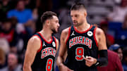 Chicago Bulls guard Zach LaVine (8) and center Nikola Vucevic (9) talk on a time out against the New Orleans Pelicans during the first half at Smoothie King Center. 