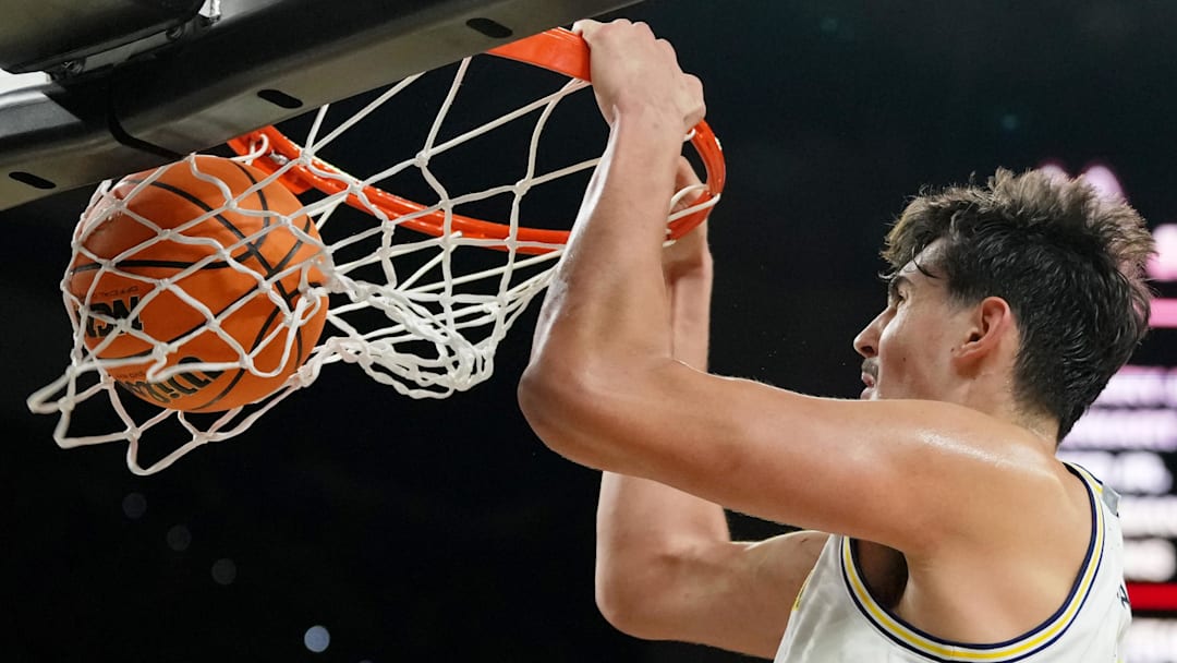 Apr 6, 2026; Indianapolis, IN, USA; Michigan Wolverines center Aday Mara (15) dunks against the UConn Huskies during the second half in the national championship of the Final Four of the men's 2026 NCAA Tournament between the  and the Michigan Wolverines at Lucas Oil Stadium.