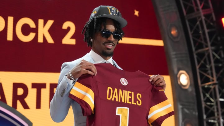 Apr 25, 2024; Detroit, MI, USA; LSU Tigers quarterback Jayden Daniels poses after being selected by the Washington Commanders as the No. 2 pick in the first round of the 2024 NFL Draft at Campus Martius Park and Hart Plaza. Mandatory Credit: Kirby Lee-USA TODAY Sports