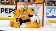 May 3, 2024; Nashville, Tennessee, USA; Nashville Predators goaltender Juuse Saros (74) makes a glove save against the Vancouver Canucks during the second period in game six of the first round of the 2024 Stanley Cup Playoffs at Bridgestone Arena. Mandatory Credit: Steve Roberts-Imagn Images