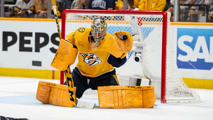 May 3, 2024; Nashville, Tennessee, USA; Nashville Predators goaltender Juuse Saros (74) makes a glove save against the Vancouver Canucks during the second period in game six of the first round of the 2024 Stanley Cup Playoffs at Bridgestone Arena. Mandatory Credit: Steve Roberts-Imagn Images