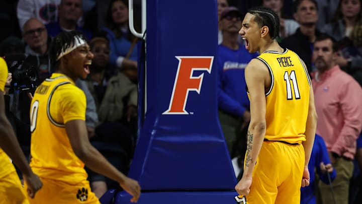 Missouri Tigers players Anthony Robinson II (0), and Trent Pierce (11), celebrate after a big bucket to extend their lead, in a game versus the Florida Gators this season.