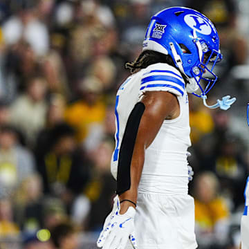 Sep 14, 2024; Laramie, Wyoming, USA; Brigham Young Cougars tight end Keanu Hill (1) celebrates a touchdown with quarterback Jake Retzlaff (12) against the Wyoming Cowboys during the first quarter at Jonah Field at War Memorial Stadium.