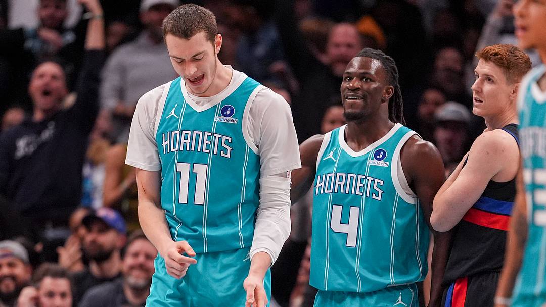 Feb 9, 2026; Charlotte, North Carolina, USA; Charlotte Hornets center Ryan Kalkbrenner (11) celebrates his dunk with guard Sion James (4) during the second half against the Detroit Pistons at Spectrum Center. Mandatory Credit: Jim Dedmon-Imagn Images