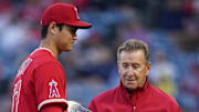 May 10, 2022; Anaheim, California, USA; Los Angeles Angels designated hitter Shohei Ohtani (17) is presented the MLB most valuable player trophy by owner Arte Moreno at Angel Stadium. 