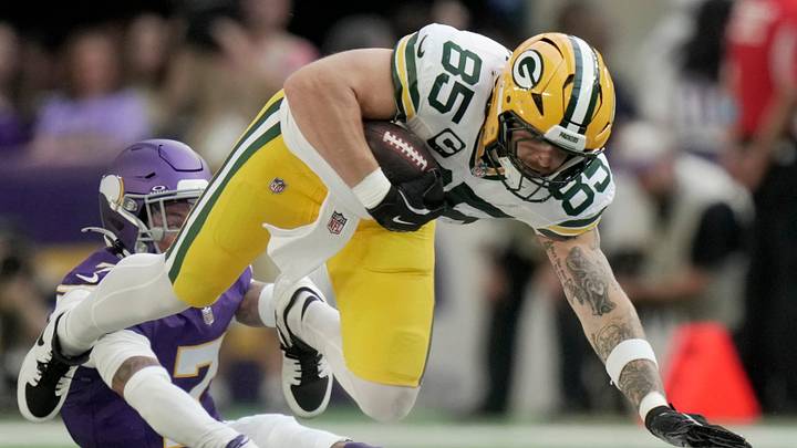 Green Bay Packers tight end Tucker Kraft (85) makes a 30-yard reception before being tackles any Minnesota Vikings cornerback Byron Murphy Jr. (7) during the second quarter of their game Sunday, Sept. 13, 2026 at U.S. Bank Stadium in Minneapolis, Minnesota.