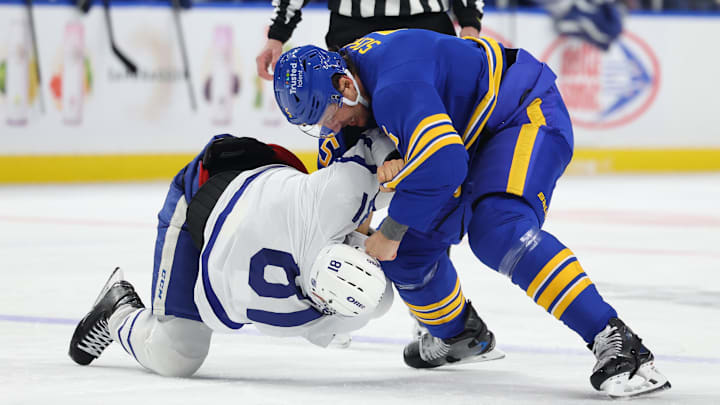 Mar 14, 2026; Buffalo, New York, USA;  Buffalo Sabres defenseman Luke Schenn (5) and Toronto Maple Leafs center Dakota Joshua (81) fight during the first period at KeyBank Center. Mandatory Credit: Timothy T. Ludwig-Imagn Images
