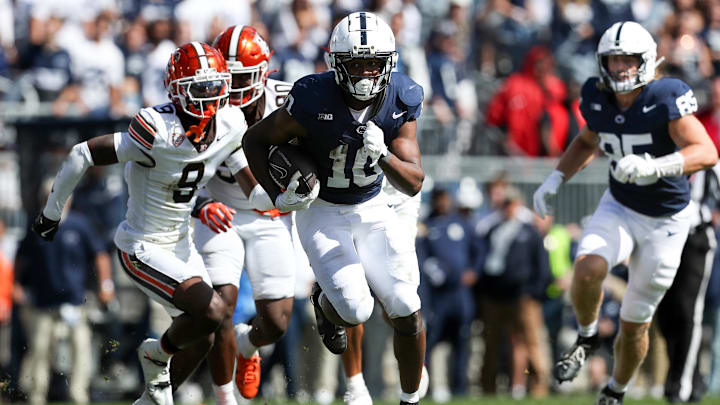 Penn State unning back Nicholas Singleton breaks through the Bowling Green line for a big gain at Beaver Stadium.