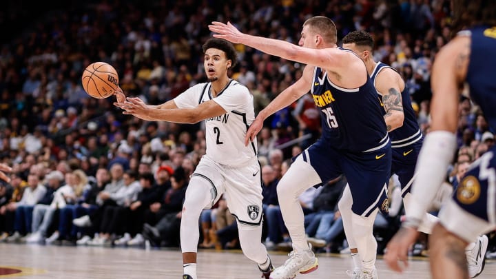 Dec 14, 2023; Denver, Colorado, USA; Brooklyn Nets forward Cam Johnson (2) passes the ball as Denver Nuggets center Nikola Jokic (15) guards in the second quarter at Ball Arena. Mandatory Credit: Isaiah J. Downing-USA TODAY Sports