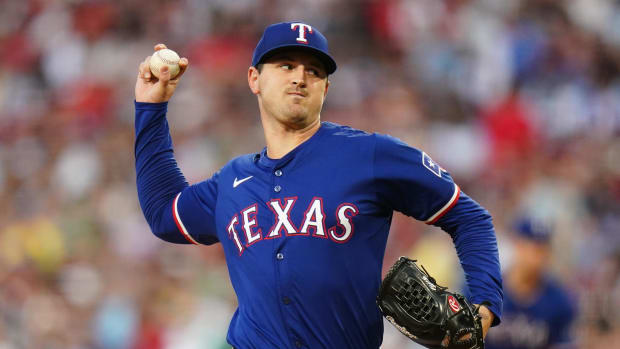 Texas Rangers pitcher Tyler Mahle throws a pitch