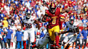 Sep 15, 2024; Landover, Maryland, USA; Washington Commanders running back Brian Robinson Jr. (8) runs the ball during the third quarter against the New York Giants at Commanders Field. Mandatory Credit: Peter Casey-Imagn Images