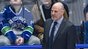 Rick Tocchet coaches the Canucks against the Avalanche.