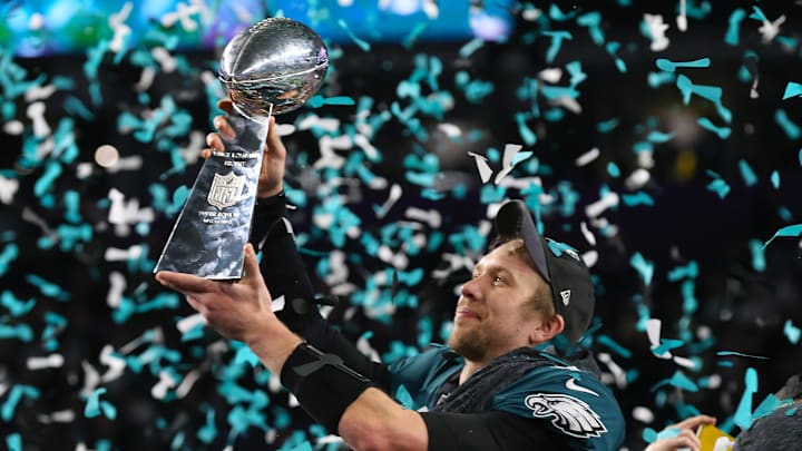 Feb 4, 2018; Minneapolis, MN, USA; Philadelphia Eagles quarterback Nick Foles (9) hoist the Vince Lombardi Trophy after a victory against the New England Patriots in Super Bowl LII at U.S. Bank Stadium. Mandatory Credit: Matthew Emmons-Imagn Images