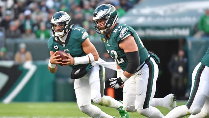 Dec 31, 2023; Philadelphia, Pennsylvania, USA; Philadelphia Eagles quarterback Jalen Hurts (1) runs with ball as center Jason Kelce (62) looks to block against the Arizona Cardinals at Lincoln Financial Field. Mandatory Credit: Eric Hartline-USA TODAY Sports