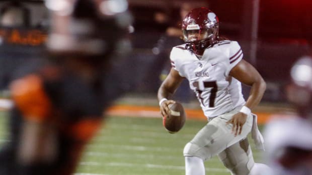 Vikings QB #17Ennio Yapoor scrambles before throwing a touchdown with seconds left before the half