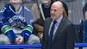 Feb 4, 2025; Vancouver, British Columbia, CAN;  Vancouver Canucks head coach Rick Tocchet on the bench against the Colorado Avalanche in the first period at Rogers Arena. Mandatory Credit: Bob Frid-Imagn Images