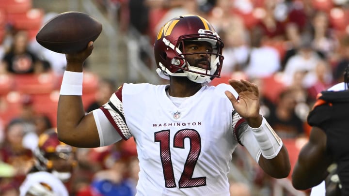 Aug 26, 2023; Landover, Maryland, USA; Washington Commanders quarterback Jacoby Brissett (12) drops back to pass against the Cincinnati Bengals during the first half at FedExField. Mandatory Credit: Brad Mills-USA TODAY Sports