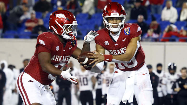 Dec 27, 2024; Memphis, TN, USA; Arkansas Razorbacks quarterback Taylen Green (10) hands the ball off to Arkansas Razorbacks running back Braylen Russell (0) during the forth quarter against the Texas Tech Red Raiders at Simmons Bank Liberty Stadium. Mandatory Credit: Petre Thomas-Imagn Images