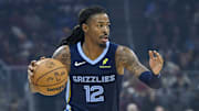 Nov 15, 2025; Cleveland, Ohio, USA; Memphis Grizzlies guard Ja Morant (12) dribbles the ball in the first quarter against the Cleveland Cavaliers at Rocket Arena. Mandatory Credit: David Richard-Imagn Images
