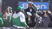 Eagles running back Saquon Barkley holds the Vince Lombardi trophy during the Eagles Super Bowl championship parade