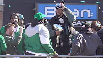 Eagles running back Saquon Barkley (center) holds the Vince Lombardi trophey during the Eagles Super Bowl championship parade in Philadelphia, PA, on Friday Feb. 14, 2025.