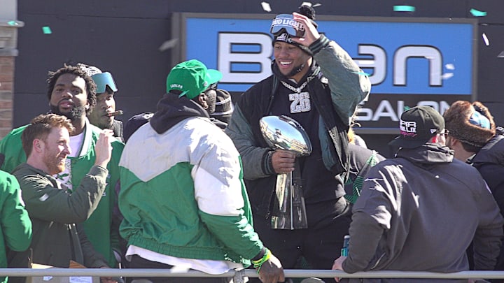 Eagles running back Saquon Barkley holds the Vince Lombardi trophy during the Eagles Super Bowl championship parade.