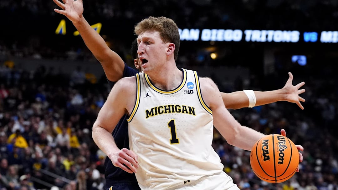 March 20, 2025; Denver, CO, USA; Michigan Wolverines center Danny Wolf (1) controls the ball against the UC San Diego Tritons during the first half at Ball Arena. Mandatory Credit: Ron Chenoy-Imagn Images