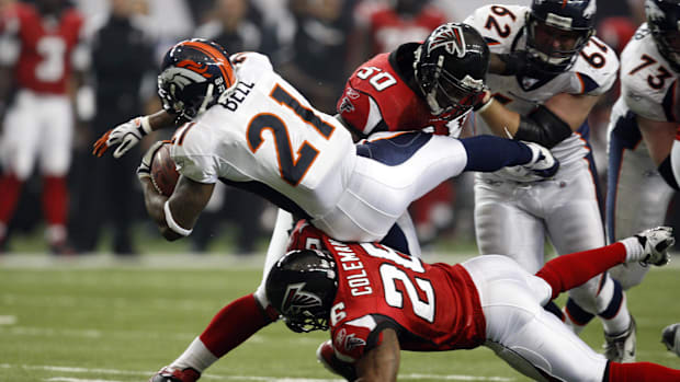 Former Duncanville running back Tatum Bell (21) goes airborne after in a Broncos-Falcons game in the Georgia Dome.