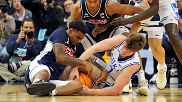 Mar 27, 2025; Newark, NJ, USA; Duke Blue Devils guard Kon Knueppel (7) and Arizona Wildcats guard KJ Lewis (5) go for the ball during the second half during an East Regional semifinal of the 2025 NCAA tournament at Prudential Center. Mandatory Credit: Robert Deutsch-Imagn Images