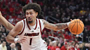Mar 1, 2025; Louisville, Kentucky, USA;  Louisville Cardinals guard J'Vonne Hadley (1) dribbles past Pittsburgh Panthers forward Cameron Corhen (2) during the second half at KFC Yum! Center. Louisville defeated Pittsburgh 79-68. Mandatory Credit: Jamie Rhodes-Imagn Images