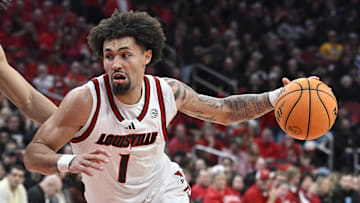 Mar 1, 2025; Louisville, Kentucky, USA;  Louisville Cardinals guard J'Vonne Hadley (1) dribbles past Pittsburgh Panthers forward Cameron Corhen (2) during the second half at KFC Yum! Center. Louisville defeated Pittsburgh 79-68. Mandatory Credit: Jamie Rhodes-Imagn Images