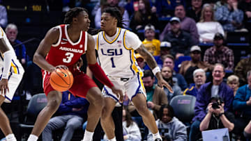 Jan 14, 2025; Baton Rouge, Louisiana, USA;  Arkansas Razorbacks forward Adou Thiero (3) dribbles against LSU Tigers guard Jordan Sears (1) during the first half at Pete Maravich Assembly Center. Mandatory Credit: Stephen Lew-Imagn Images
