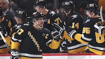 Mar 11, 2025; Pittsburgh, Pennsylvania, USA;  Pittsburgh Penguins center Sidney Crosby (87) celebrates his second goal of the game with the Penguins bench against the Vegas Golden Knights during the second period at PPG Paints Arena. Mandatory Credit: Charles LeClaire-Imagn Images