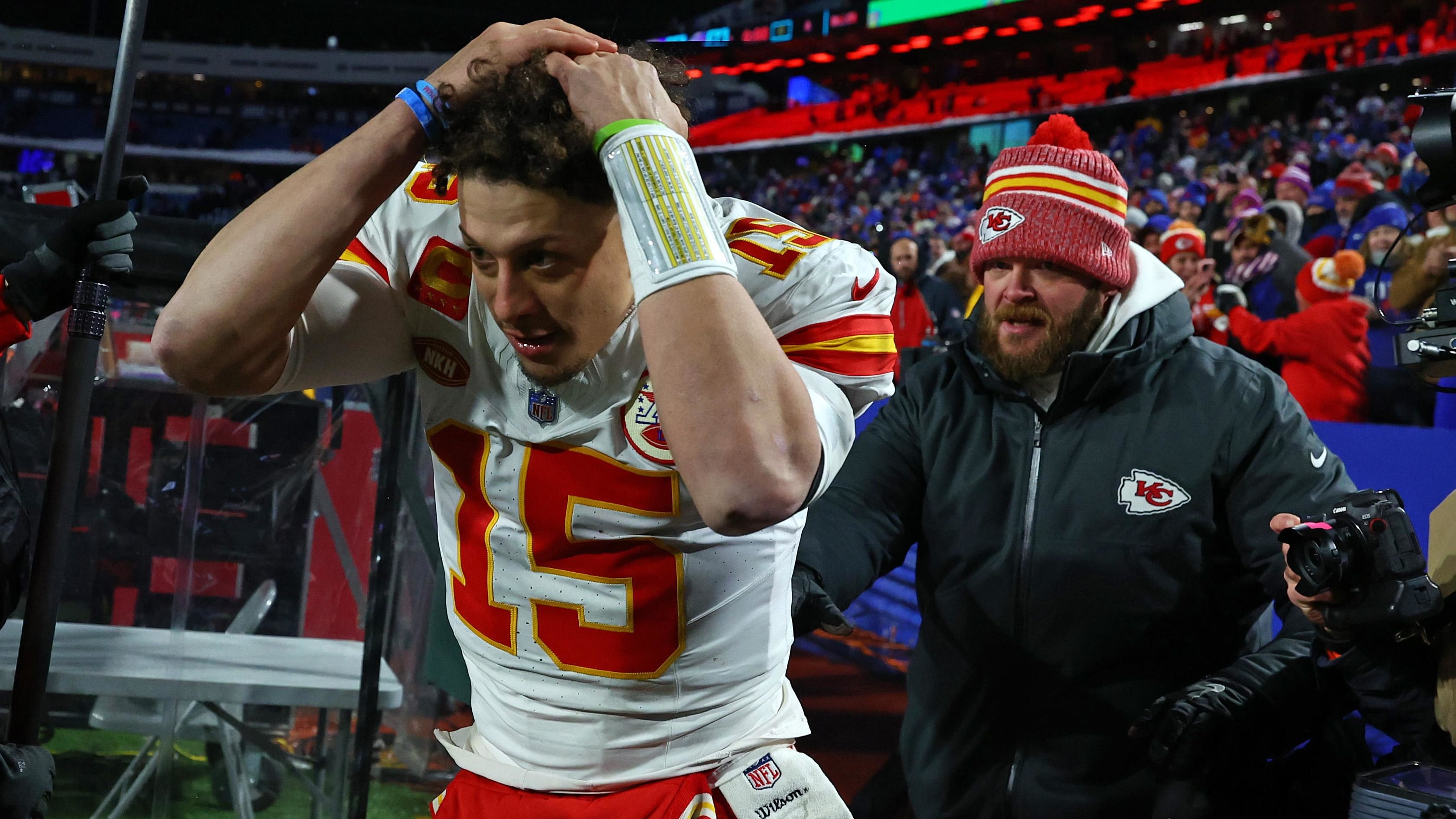 Patrick Mahomes covers his head as he walks off the field