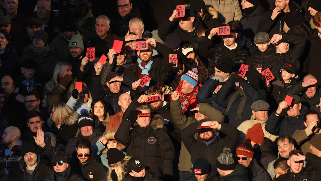 West Ham fans show their disappointment by holding up red cards to express they want owners David Sullivan and his top exectuive Karen Brady out after an embarrassing rock bottom lose to Wolverhampton. West Ham fans show their disappointment by holding up red cards to express they want owners David Sullivan and his top exectuive Karen Brady out after an embarrassing rock bottom lose to Wolverhampton.